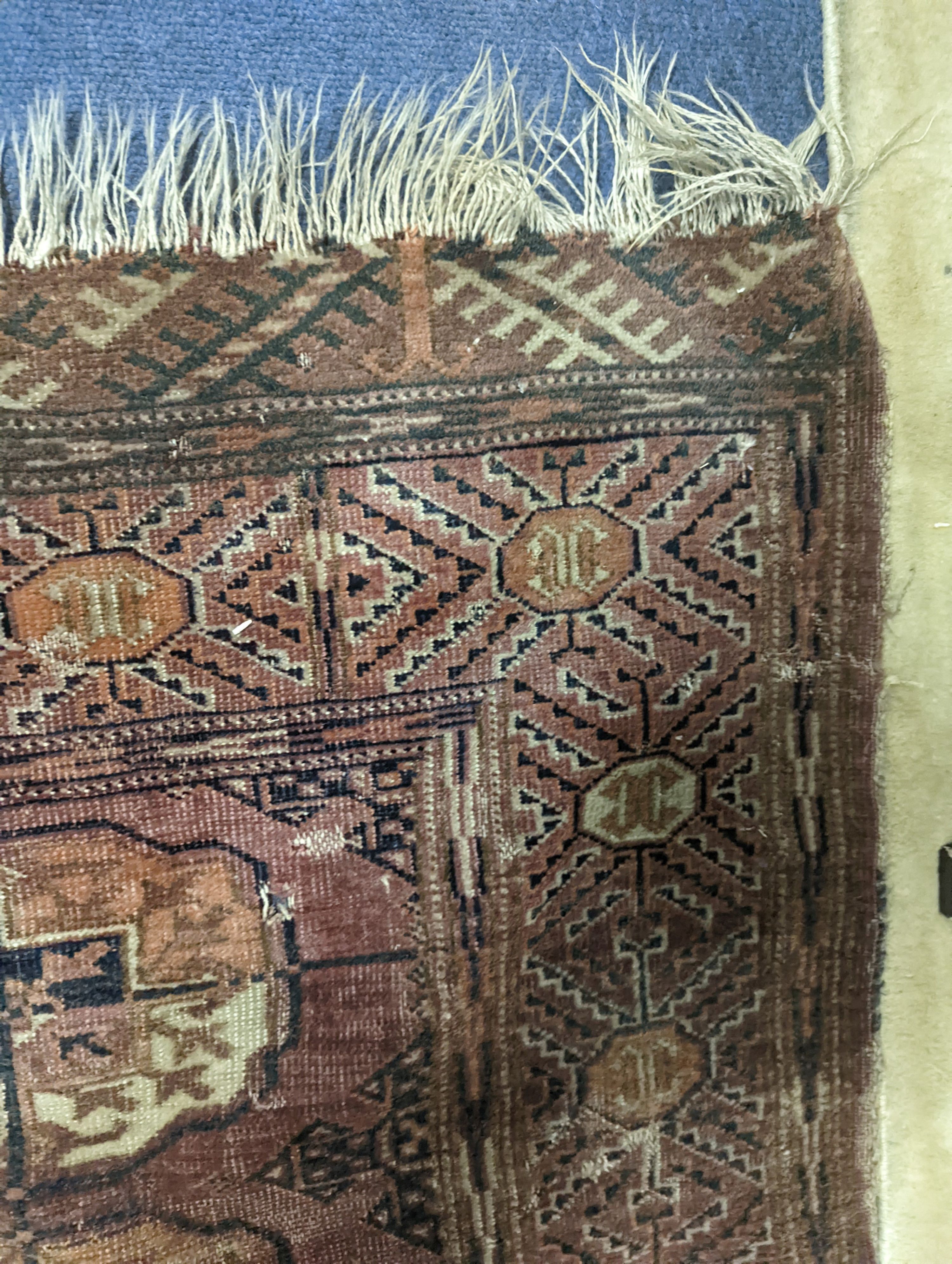 A Bokhara red ground rug. 147x133cm.